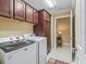 Convenient laundry room with ample cabinet space and washer/dryer at 3416 Eisenhower Way, The Villages, FL 32163