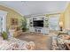 Living room with built-in shelving and large TV at 3416 Eisenhower Way, The Villages, FL 32163