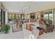 Sunroom with ample seating, large windows, and access to backyard at 3416 Eisenhower Way, The Villages, FL 32163