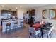 Open kitchen with island, granite countertops, and adjacent dining area at 348 Hickory Course Trl, Ocala, FL 34472