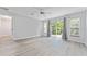 Bright bedroom featuring wood-look floors and access to backyard at 4480 Nw 79Th Terrace Rd, Ocala, FL 34482