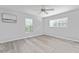 Bright bedroom with wood-look floors, ceiling fan, and large window at 4480 Nw 79Th Terrace Rd, Ocala, FL 34482