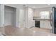 Bright kitchen with white cabinets, granite counters, and black appliances at 4480 Nw 79Th Terrace Rd, Ocala, FL 34482