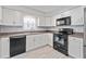 Modern kitchen with white cabinets, granite countertops, and black appliances at 4480 Nw 79Th Terrace Rd, Ocala, FL 34482