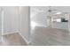 Open living room with wood-look floors and kitchen view at 4480 Nw 79Th Terrace Rd, Ocala, FL 34482