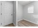 Small room with wood-look floors and a window with blinds at 4480 Nw 79Th Terrace Rd, Ocala, FL 34482