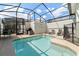 Private screened-in pool with lounge chairs and a grill at 4811 Memories Ln, Kissimmee, FL 34746