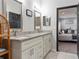 Double vanity bathroom with granite counters and view of bedroom at 4880 Sw 106Th St, Ocala, FL 34476