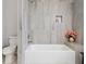 Bathroom features a shower/tub combo and gray tile at 4880 Sw 106Th St, Ocala, FL 34476
