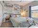 Spacious bedroom with wood-like accent wall and king bed at 4880 Sw 106Th St, Ocala, FL 34476