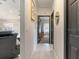 Bright hallway with tile floors and access to bedrooms at 4880 Sw 106Th St, Ocala, FL 34476
