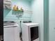 Laundry room with washer, dryer, and shelving at 4880 Sw 106Th St, Ocala, FL 34476