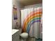 Bathroom with rainbow shower curtain and tiled floor at 52 Pine Trak # G 104, Ocala, FL 34472
