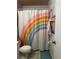 Bathroom with rainbow shower curtain and tiled floor at 52 Pine Trak # G 104, Ocala, FL 34472