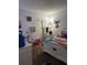 bedroom with Stitch-themed decor and white furniture at 52 Pine Trak # G 104, Ocala, FL 34472