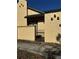Tan stucco exterior of home with a small gate and walkway at 52 Pine Trak # G 104, Ocala, FL 34472