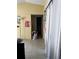 Hallway with tiled floor, laundry basket, and bathroom door at 52 Pine Trak # G 104, Ocala, FL 34472