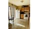 Galley kitchen with white appliances and wood cabinets at 52 Pine Trak # G 104, Ocala, FL 34472