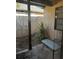Small patio with a table and chairs, surrounded by stucco walls at 52 Pine Trak # G 104, Ocala, FL 34472