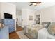 Spacious bedroom with a ceiling fan, dresser, and a comfortable bed at 5908 Nw 24Th St, Ocala, FL 34482