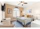 Bedroom with a comfortable bed, ceiling fan and wicker furniture at 5908 Nw 24Th St, Ocala, FL 34482