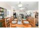 Rustic dining room with wooden table and chairs, and kitchen views at 5908 Nw 24Th St, Ocala, FL 34482