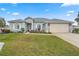 Single-story home with a two-car garage and landscaped front yard at 5908 Nw 24Th St, Ocala, FL 34482