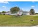Side view of house showcasing landscaping and lawn at 5908 Nw 24Th St, Ocala, FL 34482