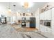 Bright kitchen with white cabinets, granite counters, and wood floors at 5908 Nw 24Th St, Ocala, FL 34482