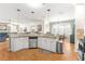 Modern kitchen with granite island, white cabinets and stainless steel appliances at 5908 Nw 24Th St, Ocala, FL 34482