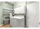Laundry room with washer, dryer, and storage shelves at 5908 Nw 24Th St, Ocala, FL 34482