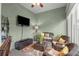 Comfortable sunroom with wicker furniture and a large TV at 5908 Nw 24Th St, Ocala, FL 34482