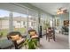 Bright sunroom with wicker furniture and backyard view at 5908 Nw 24Th St, Ocala, FL 34482