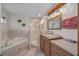 Bathroom featuring a tub, glass shower, vanity, and decorative mirror at 6009 Sw 107Th St, Ocala, FL 34476