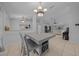 Bright dining area features a stylish chandelier, a gray table with seating, and an open floor plan at 6009 Sw 107Th St, Ocala, FL 34476