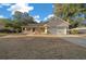 Charming home featuring a two-car garage, front porch, and well-manicured lawn at 6009 Sw 107Th St, Ocala, FL 34476
