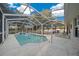 Screened-in pool area includes a sparkling pool, a patio and lounge chairs at 6009 Sw 107Th St, Ocala, FL 34476