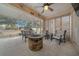 Cozy sunroom with ceiling fan, outdoor seating, and stone fire pit, perfect for relaxing and entertaining at 6009 Sw 107Th St, Ocala, FL 34476