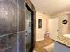 A bathroom featuring a glass door shower with dark and light tiled walls at 6701 Se 99Th Pl, Belleview, FL 34420