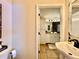 View into the bathroom featuring double vanity and a walk-in shower at 6701 Se 99Th Pl, Belleview, FL 34420