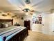 This bedroom features a comfortable bed, ceiling fan and decorative vinyl records and posters at 6701 Se 99Th Pl, Belleview, FL 34420