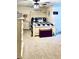 Cozy farmhouse style bedroom with a comfortable bed, ceiling fan, and rustic decor elements at 6701 Se 99Th Pl, Belleview, FL 34420