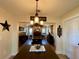 An open dining room with a decorative chandelier and stylish decor at 6701 Se 99Th Pl, Belleview, FL 34420