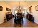 Dining room with a dark wood table, stylish décor, and large windows at 6701 Se 99Th Pl, Belleview, FL 34420