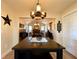 Open dining room with modern light fixture and view of a cozy breakfast nook at 6701 Se 99Th Pl, Belleview, FL 34420