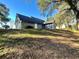 Back exterior view of the home with lush green landscaping and private backyard at 6701 Se 99Th Pl, Belleview, FL 34420