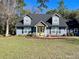 Charming two-story home with a beautifully landscaped front yard and inviting yellow front door at 6701 Se 99Th Pl, Belleview, FL 34420