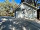 Exterior of a two-car garage featuring blue siding, white doors, and stone accents at 6701 Se 99Th Pl, Belleview, FL 34420