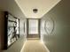 A hallway with neutral carpeting and grey walls has unique decor throughout at 6701 Se 99Th Pl, Belleview, FL 34420