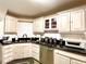 Bright kitchen features black countertops, white cabinets, and updated stainless steel dishwasher at 6701 Se 99Th Pl, Belleview, FL 34420